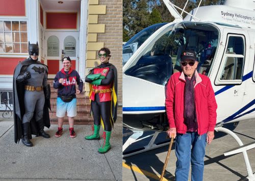 Young man at Movieworld with live characters Batman and Robin; and elderly lady with walking stick and Dream2Live4 hat standing outside a helicopter
