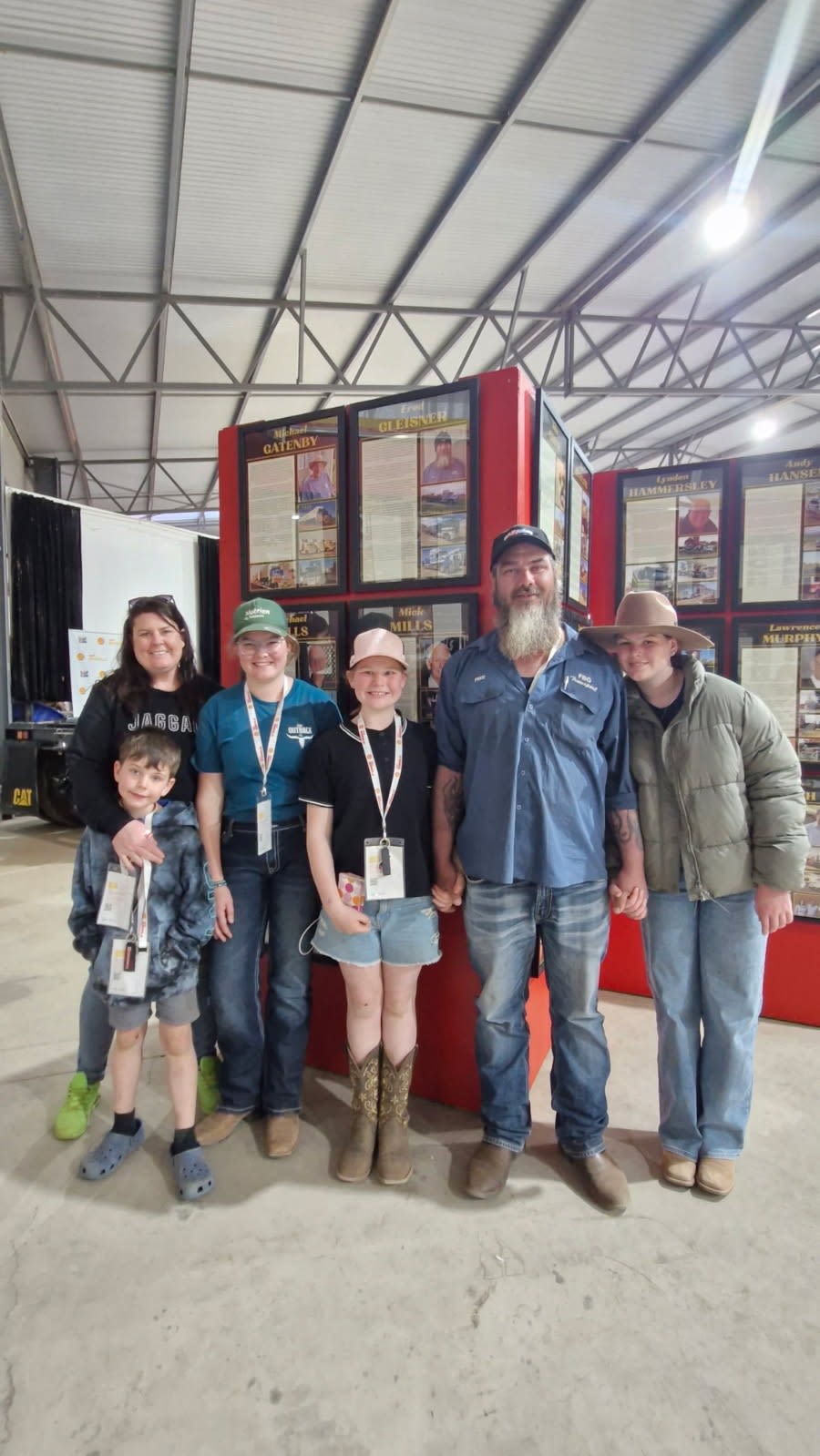 Man and kids in front of wall of fame